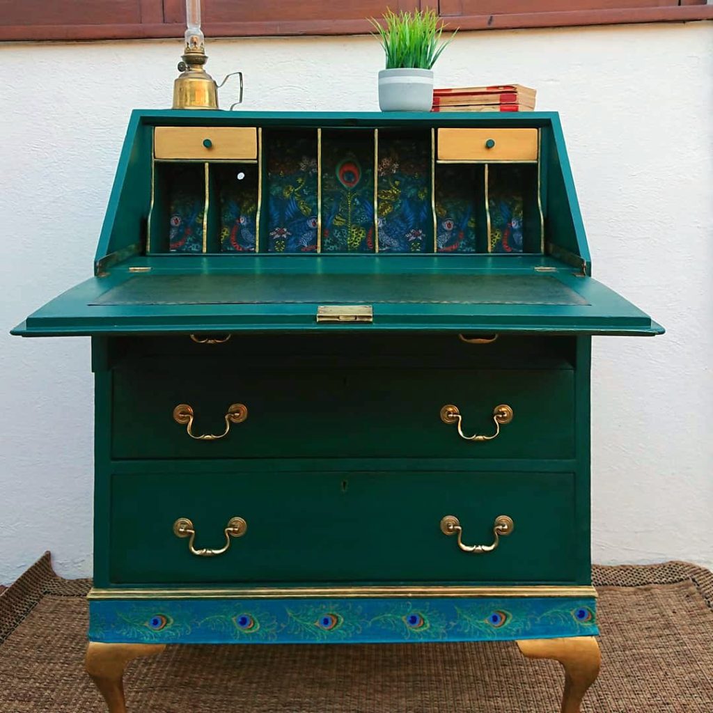 Beautiful 1930's Bureau which was commissioned to feature a custom turquoise colour and Emma J Shipley wallpaper as a detail.
There was a hand- painted peacock feather to the front and Peacock themed ribbon. Gold Legs and a new Leather writing insert were also incorporated